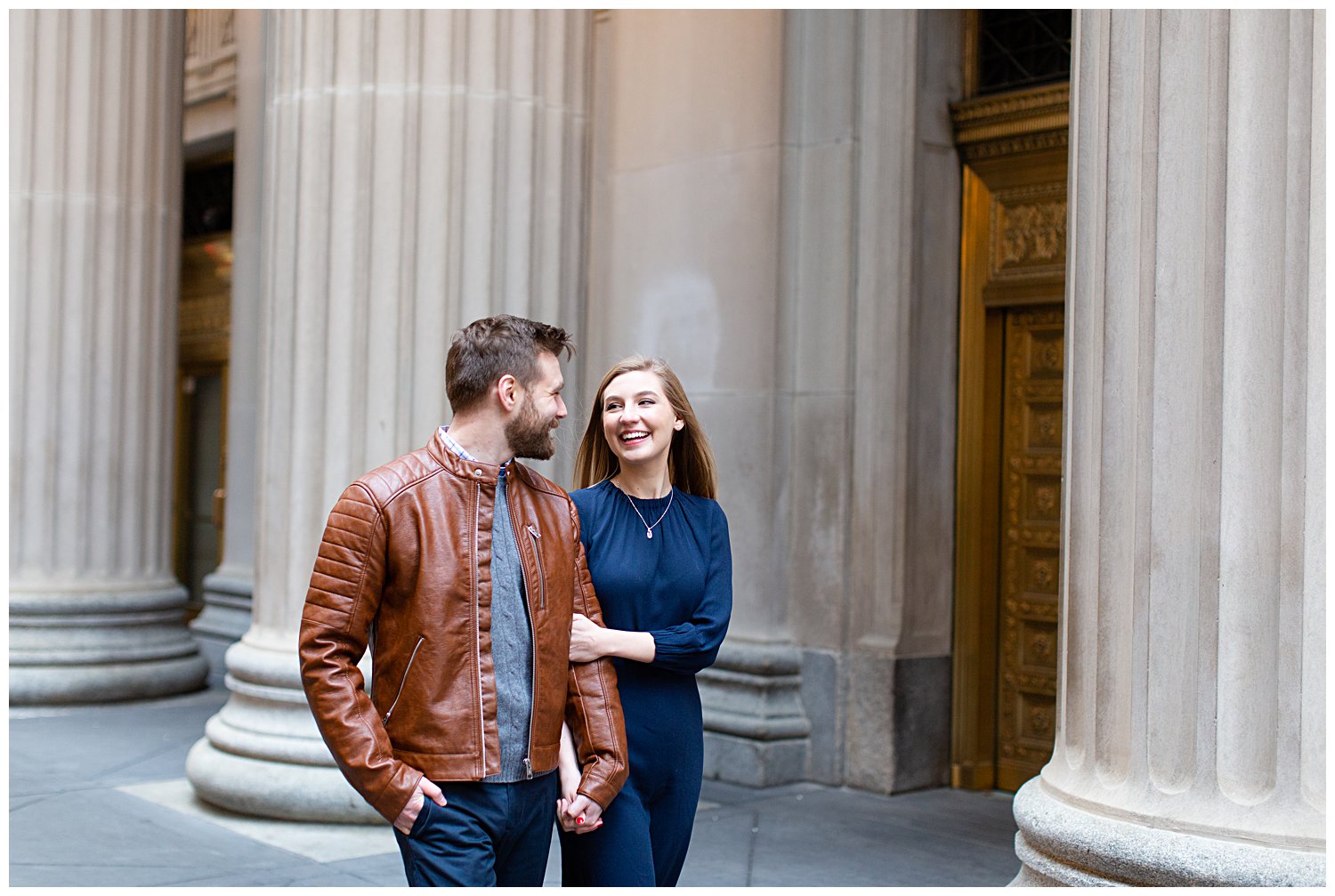 Couple posing for engagement photos outside the Chicago Board of Trade Building