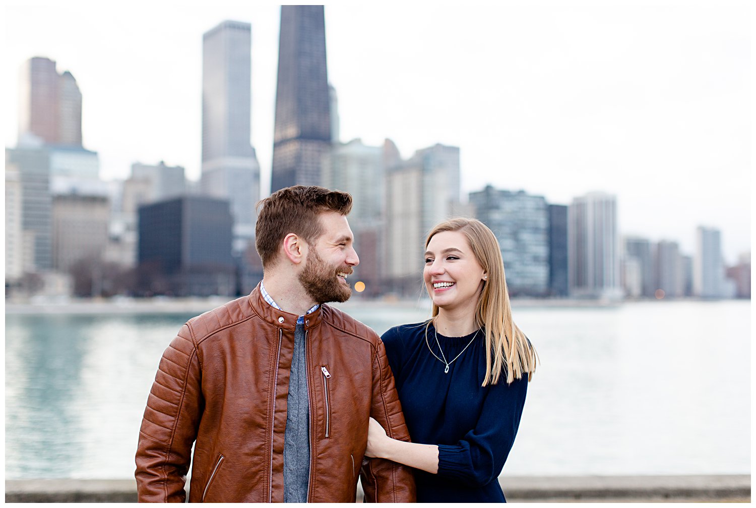 Couple posing for engagement photos at Olive Park in Chicago