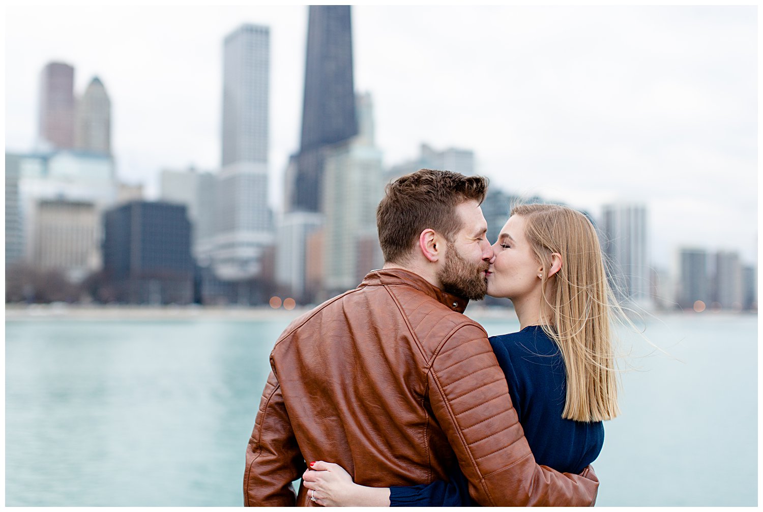 Couple posing for engagement photos at Olive Park in Chicago