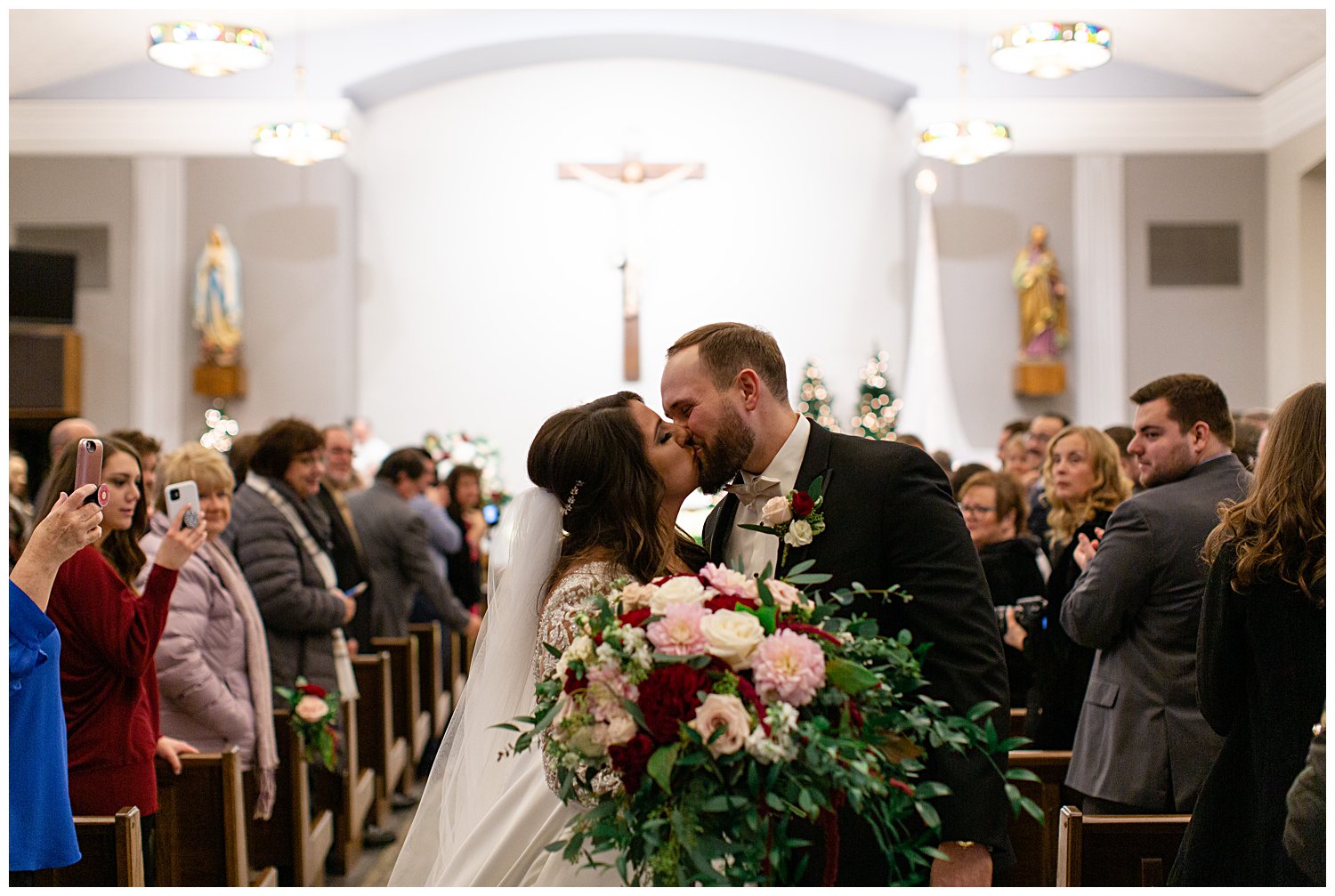 couple kissing after they walk down the aisle