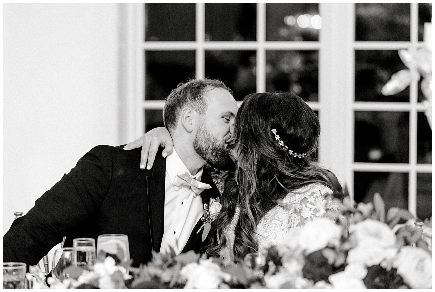 couple kissing at reception